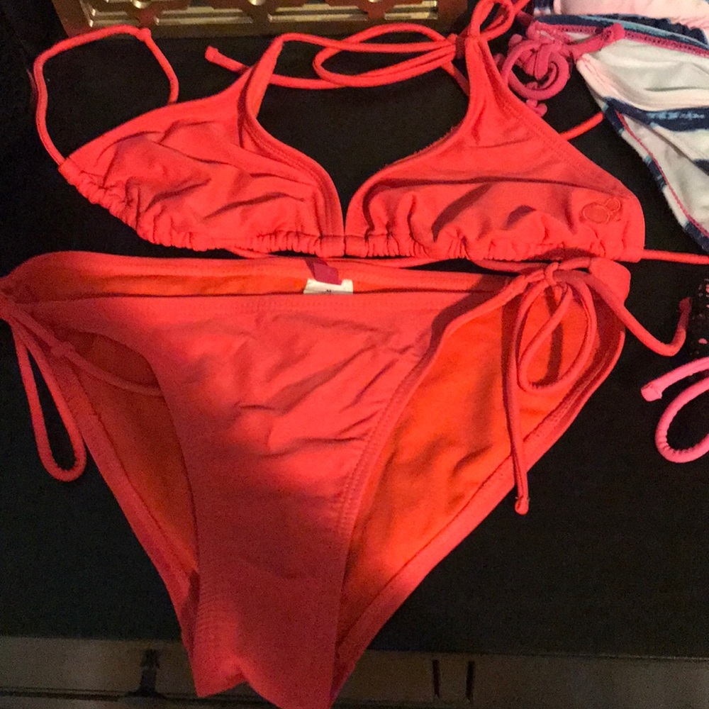4 bikini sets and 1 lone black and pink bottoms